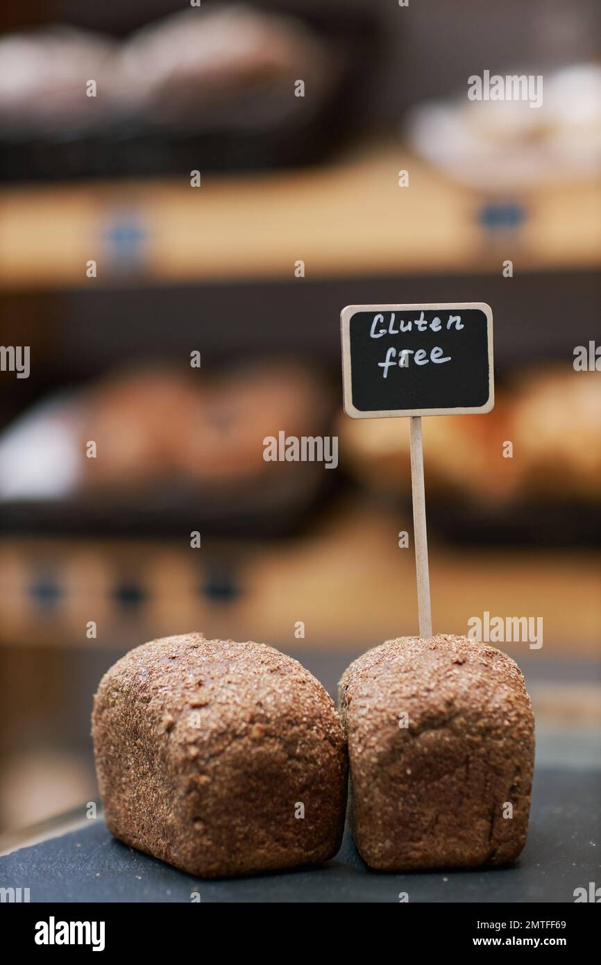 Two small gluten-free loafs of bread on table in bakery Stock Photo