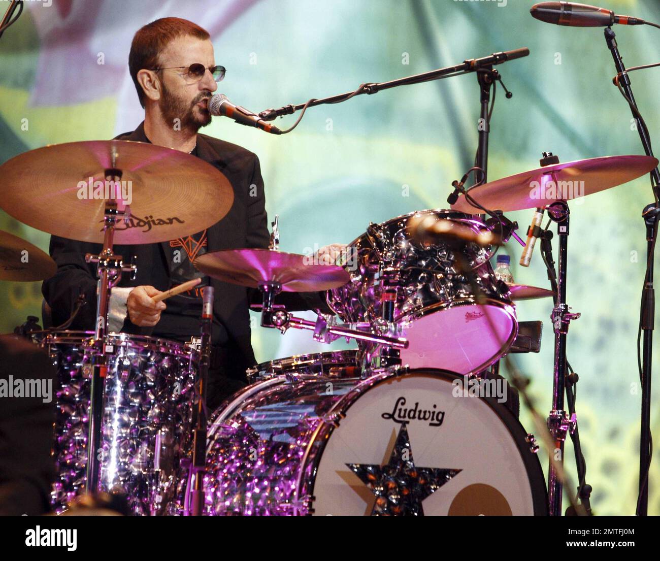 Former Beatle Ringo Starr (Richard Starkey) sings and plays the drums during a live performance with his All-Star Band at Hard Rock Live inside the Seminole Hard Rock Hotel & Casino. Before the show Ringo spoke to the Hard Rock staff and showed off some of his artwork.  After the show Ringo reportedly donated the drum kit he's been using during his All-Star Band tour to The Hard Rock Cafe, combining his charitable efforts with Hard Rock International, which donated $197,500 to Yele Haiti, a Haitian Relief fund. Hollywood, FL. 07/15/10. Stock Photo