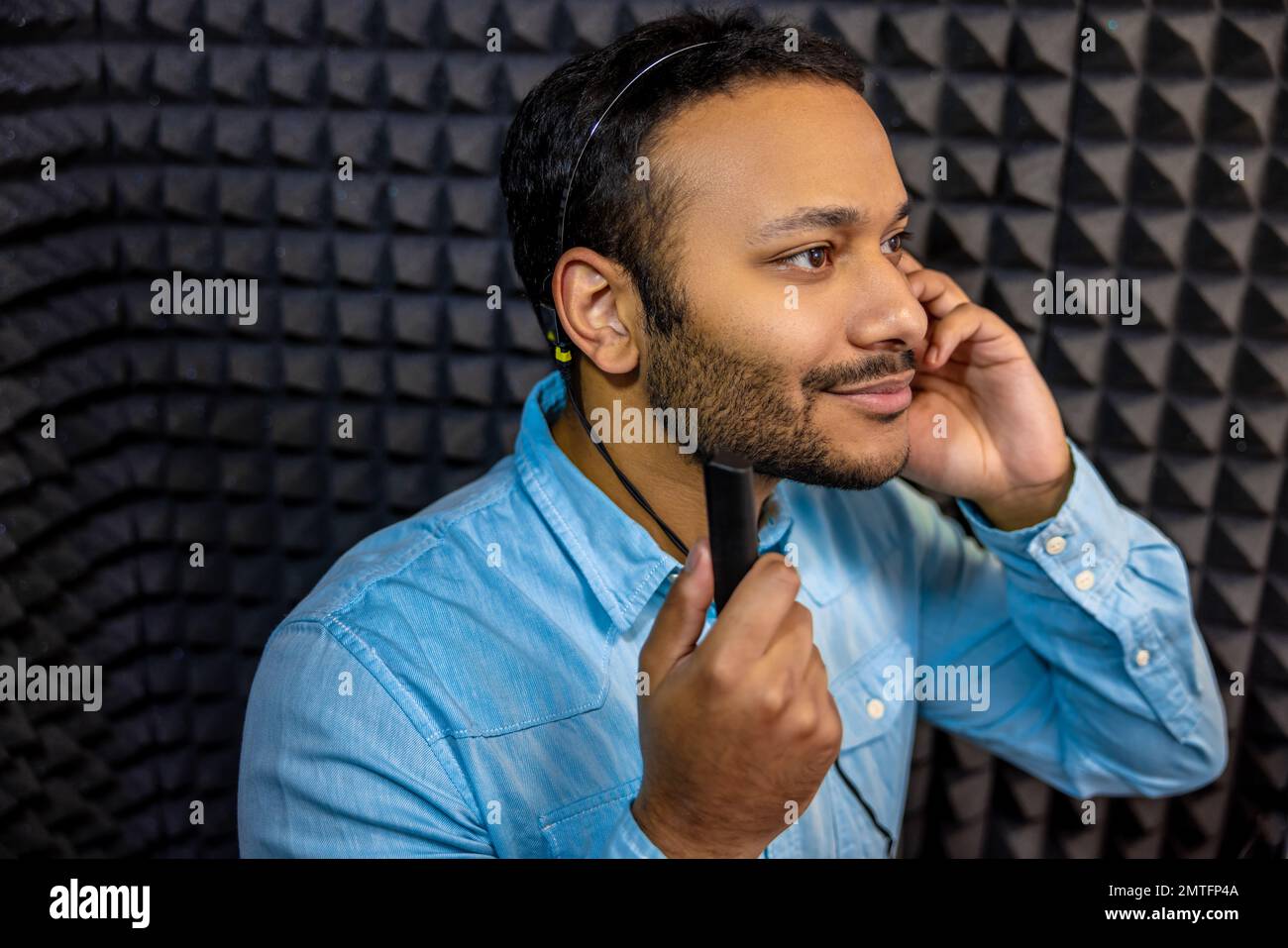 Smiling young man having a hearing checkup Stock Photo