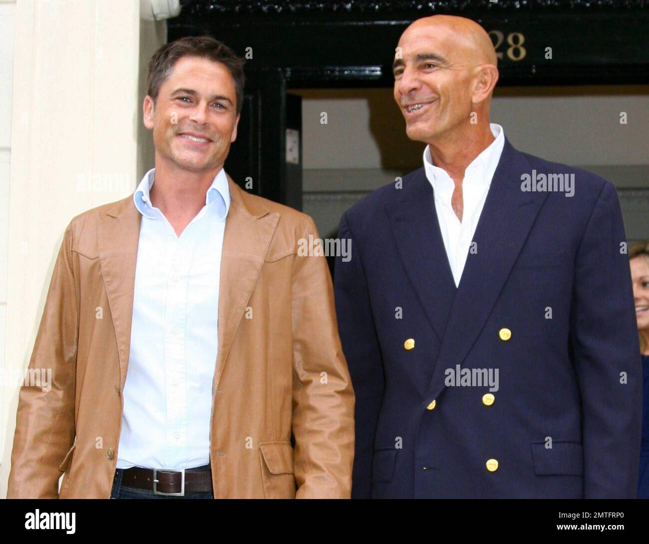 Actor rob lowe waves to photographers as he leaves a private members