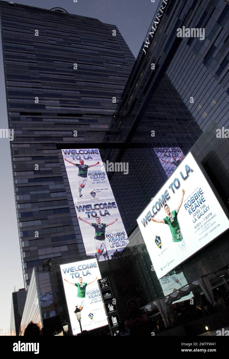 EXCLUSIVE!! The newest addition to the LA Galaxy soccer team, Irish footballer Robbie Keane poses with a billboard welcoming him to LA while out and about with a friend. Earlier in the day, Keane took part in his first practice with the team and attended a press conference with David Beckham to discuss his addition to the team. Los Angeles, CA. 19th August 2011. Stock Photo