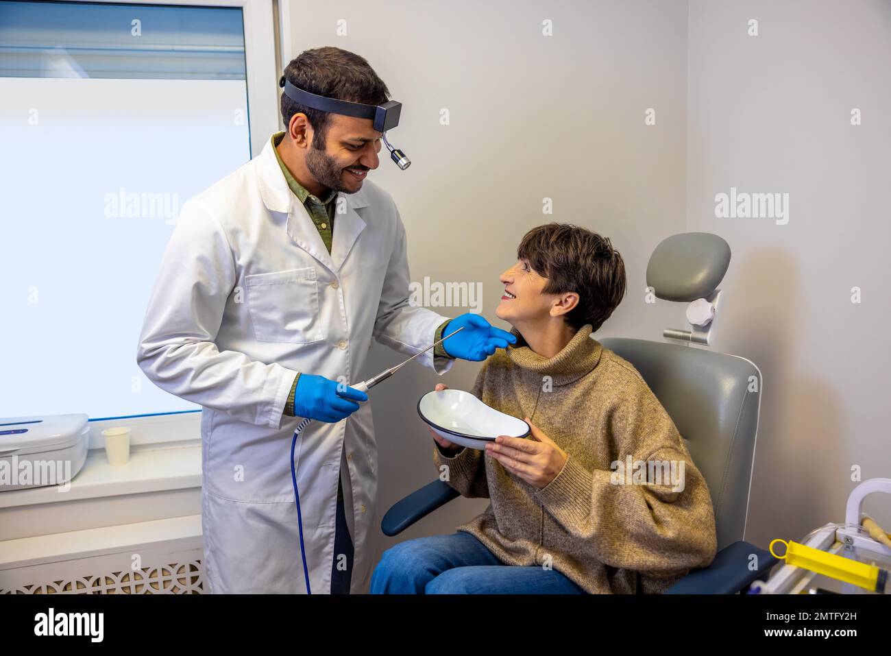 Senior woman having larynx checkup at ent doctor Stock Photo