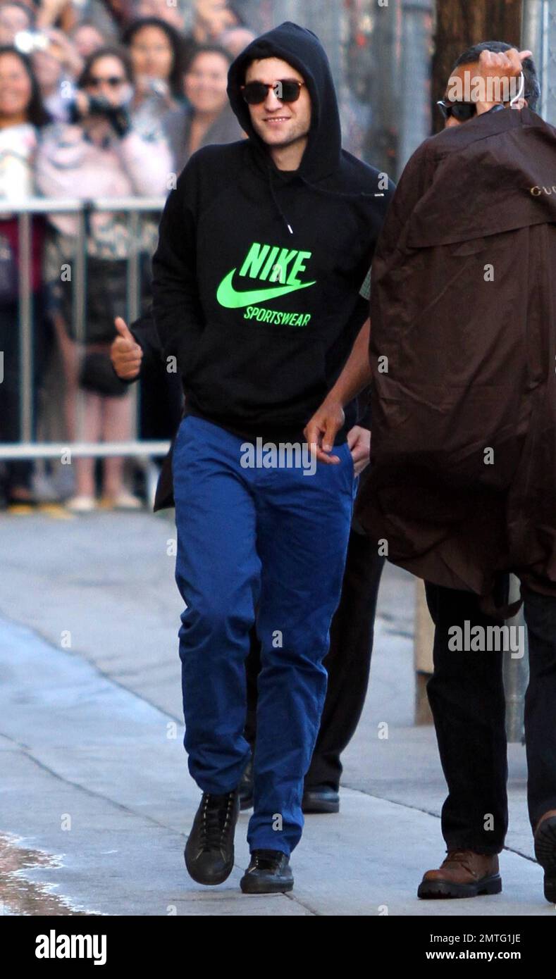 Wearing a black Nike hooded sweatshirt, blue pants and black high-top  sneakers, "Twilight Saga" star Robert Pattinson arrives at the "Jimmy  Kimmel Live" studios. Pattinson is currently promoting his new movie "Water