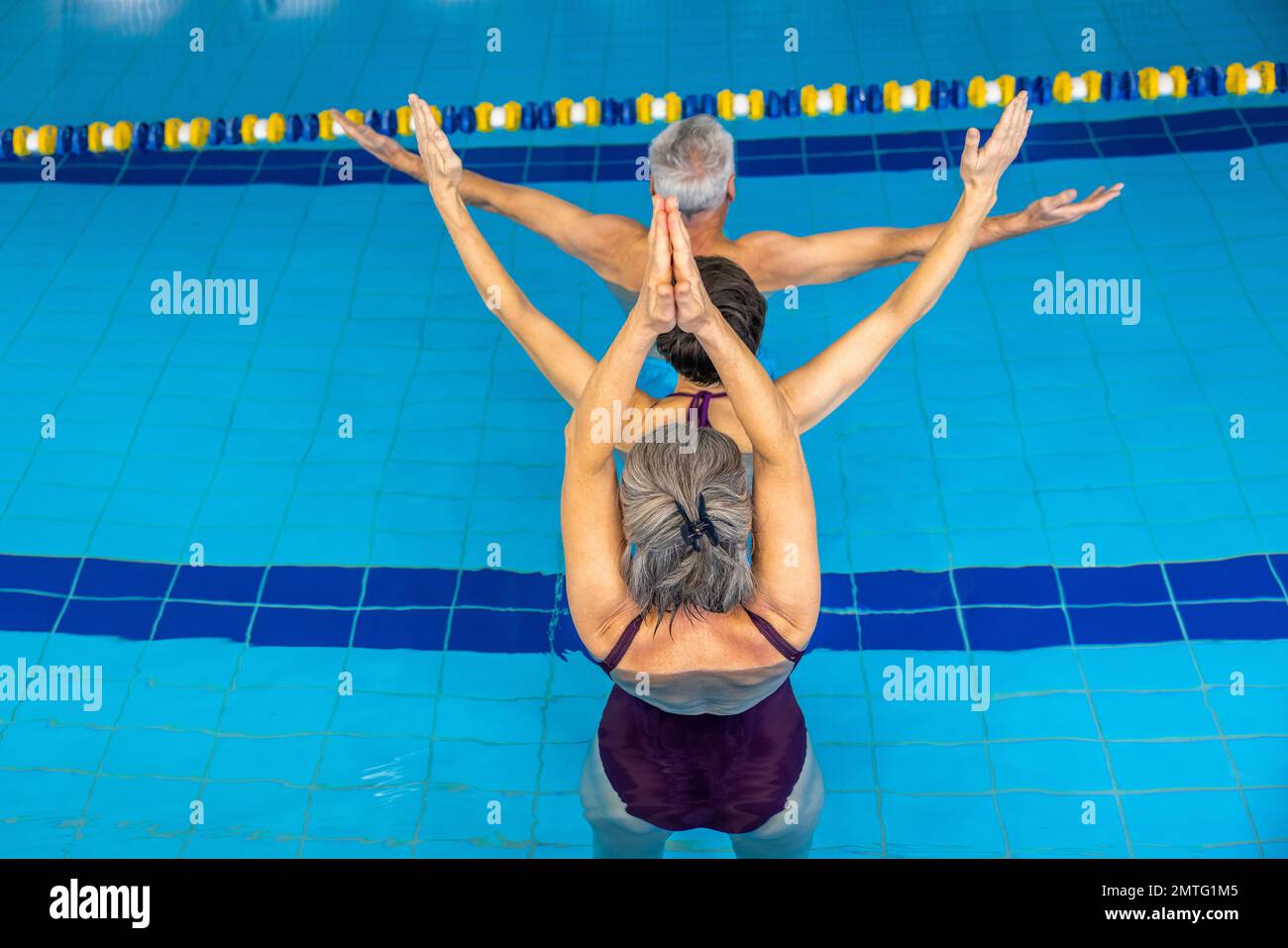 Group of people doing exercising in water at the swimming pool Stock Photo