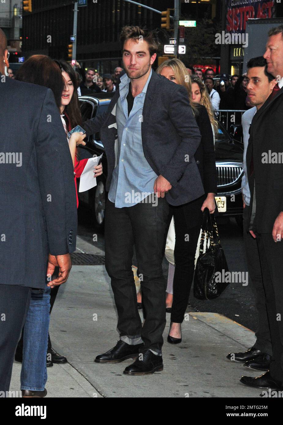 'Twilight Saga' star Robert Pattinson poses for photos outside the 'Late Show with David Letterman' studios. Pattinson, best known for his character Edward Cullen, is currently promoting the latest movie in the series 'Breaking Dawn Part 1' due in theaters on November 18. New York, NY. 8th November 2011.    . Stock Photo
