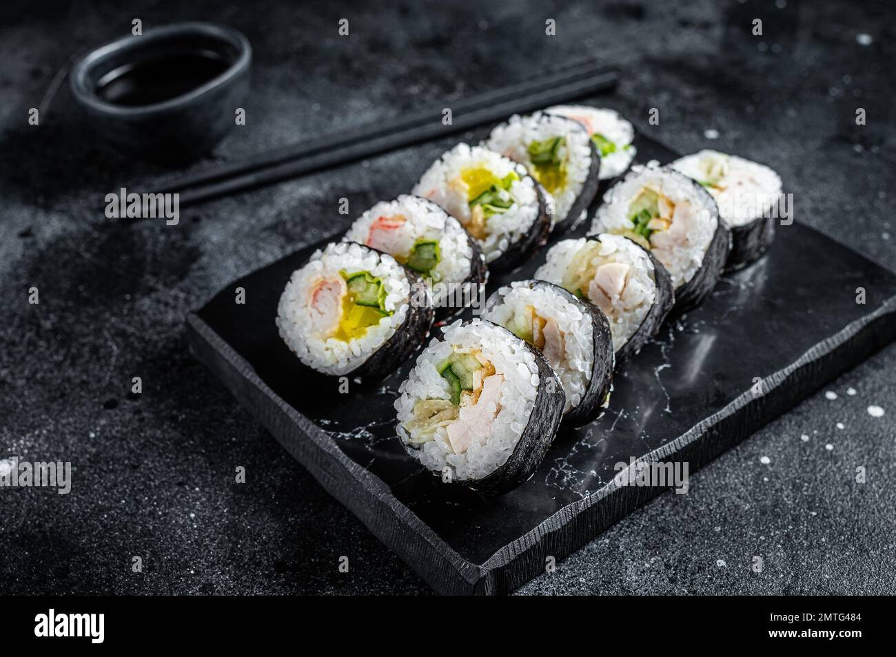 Korean rice roll Kimbap or gimbap, Korean sushi. Black background. Top view. Stock Photo