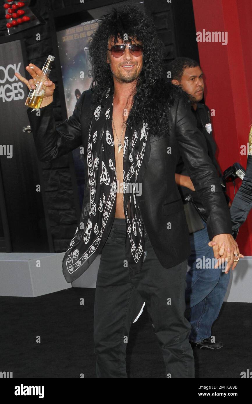Josh Duhamel wears a rocker costume and carries a beer and cigarette as he  and wife Fergie attend the 