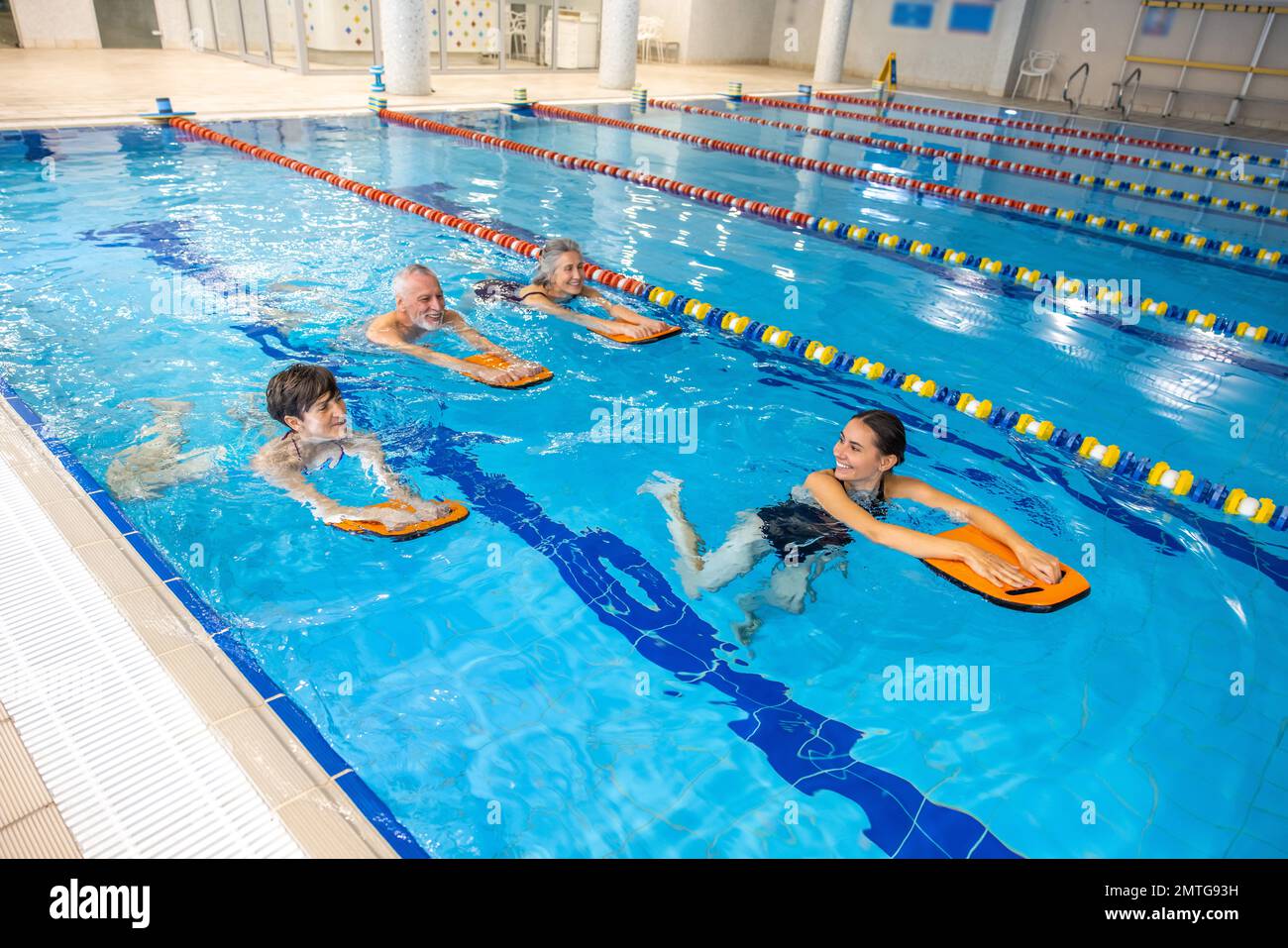 Group of people swimming in the swimming pool and looking enjoyed Stock Photo