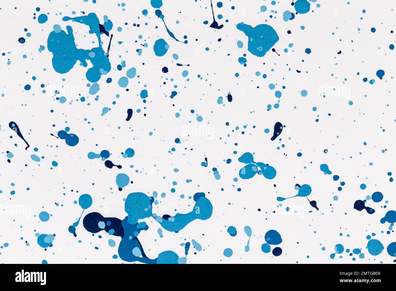 Blue drops paint texture background blue color on white paper. Brush