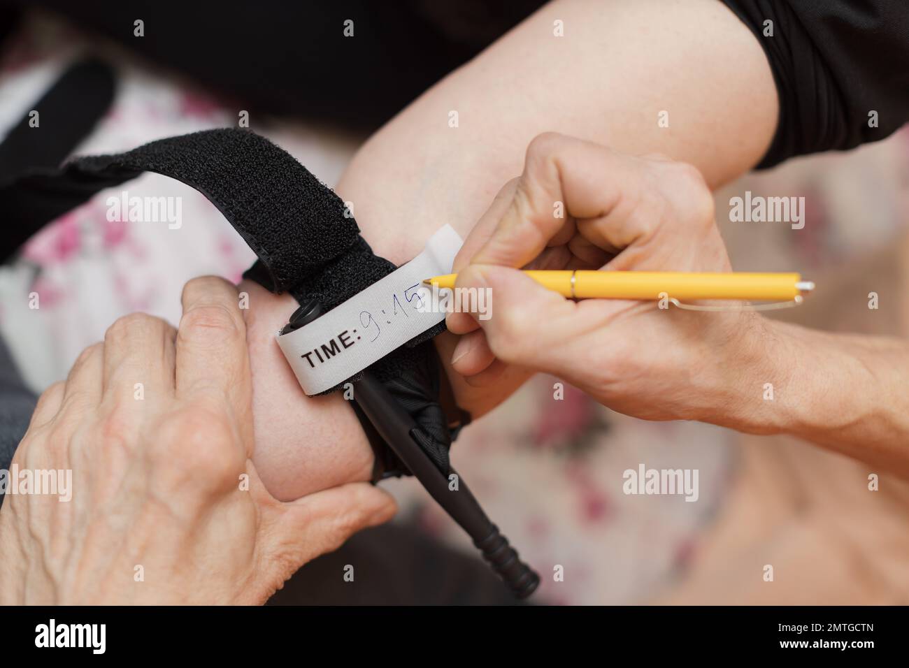 Writing a time on applied tourniquet older women arm Stock Photo Alamy
