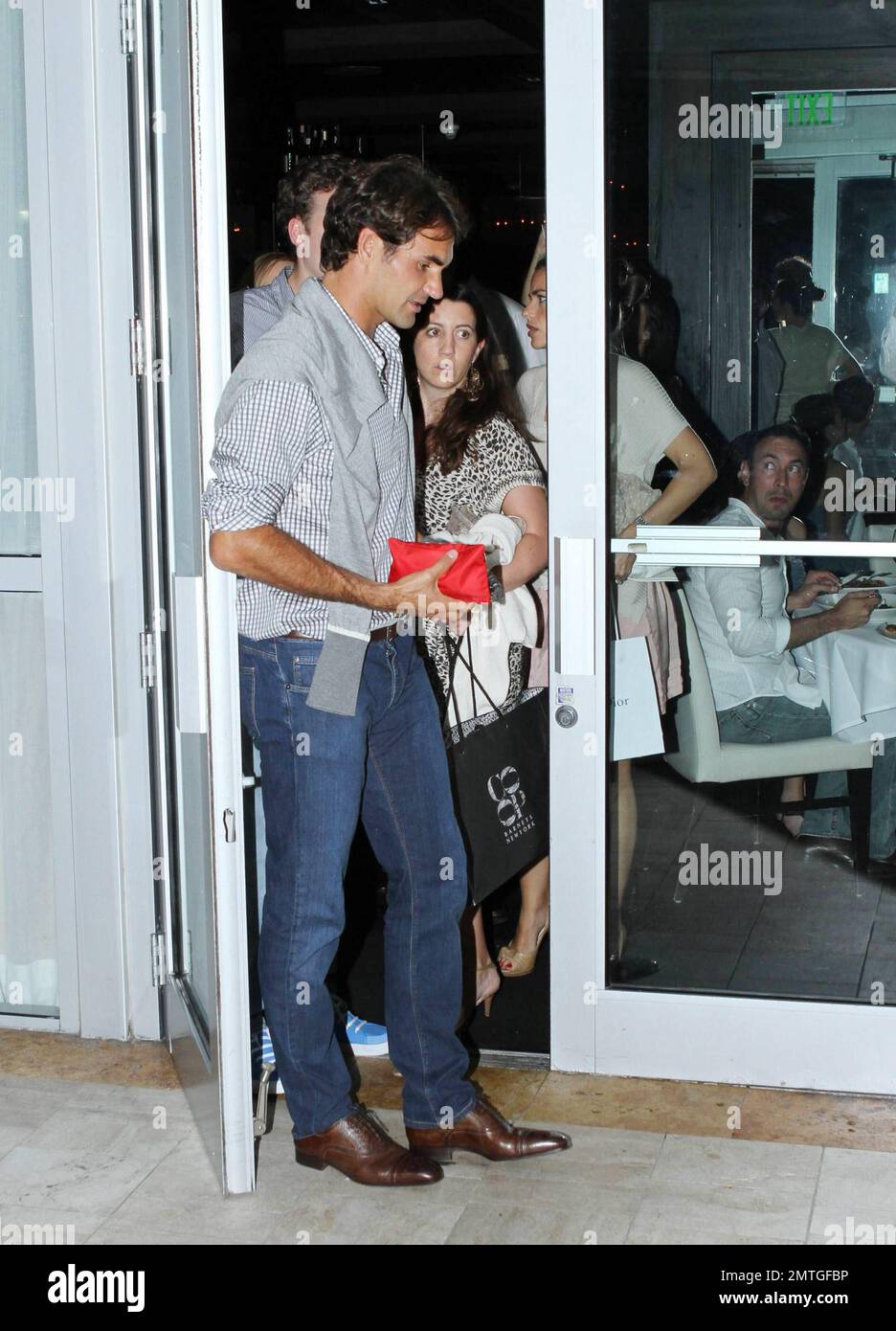 Swiss tennis champion Roger Federer celebrates his wife Mirka Federer's ...
