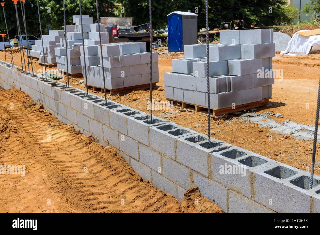 On construction site cement blocks that are ready be used to build wall of house are stacked up Stock Photo