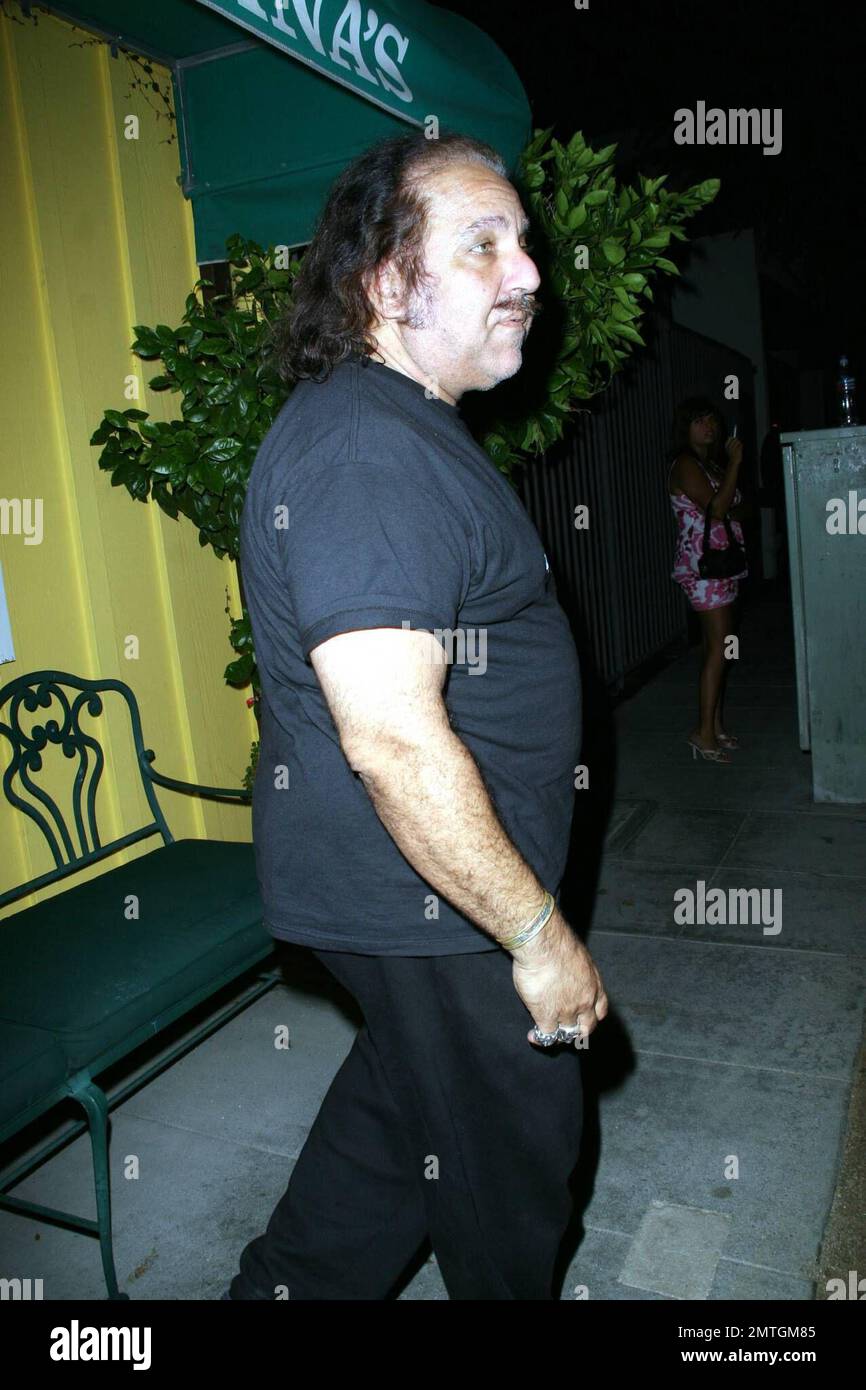 Former adult film star Ron Jeremy takes a break, stopping to sit on a bench, at Dan Tanas. Los Angeles, CA. 7/17/08. Stock Photo