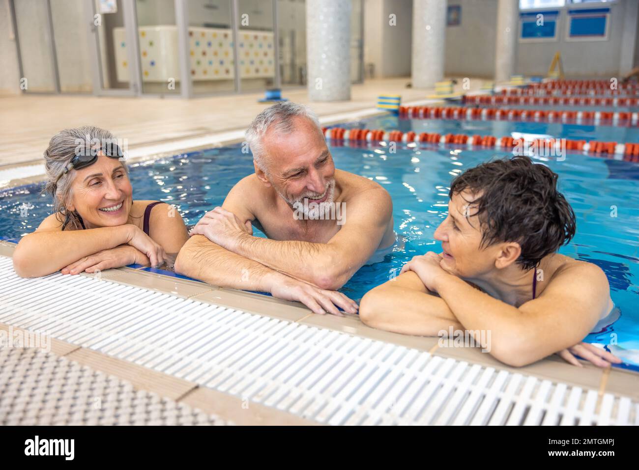 Group of seniors at the swimming pool looking happy and enjoyed Stock Photo