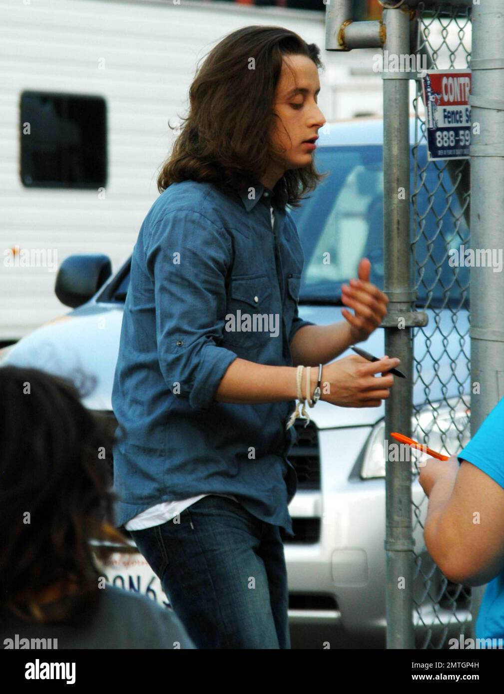 Rory Culkin shows off his long hair as he signs autographs for fans
