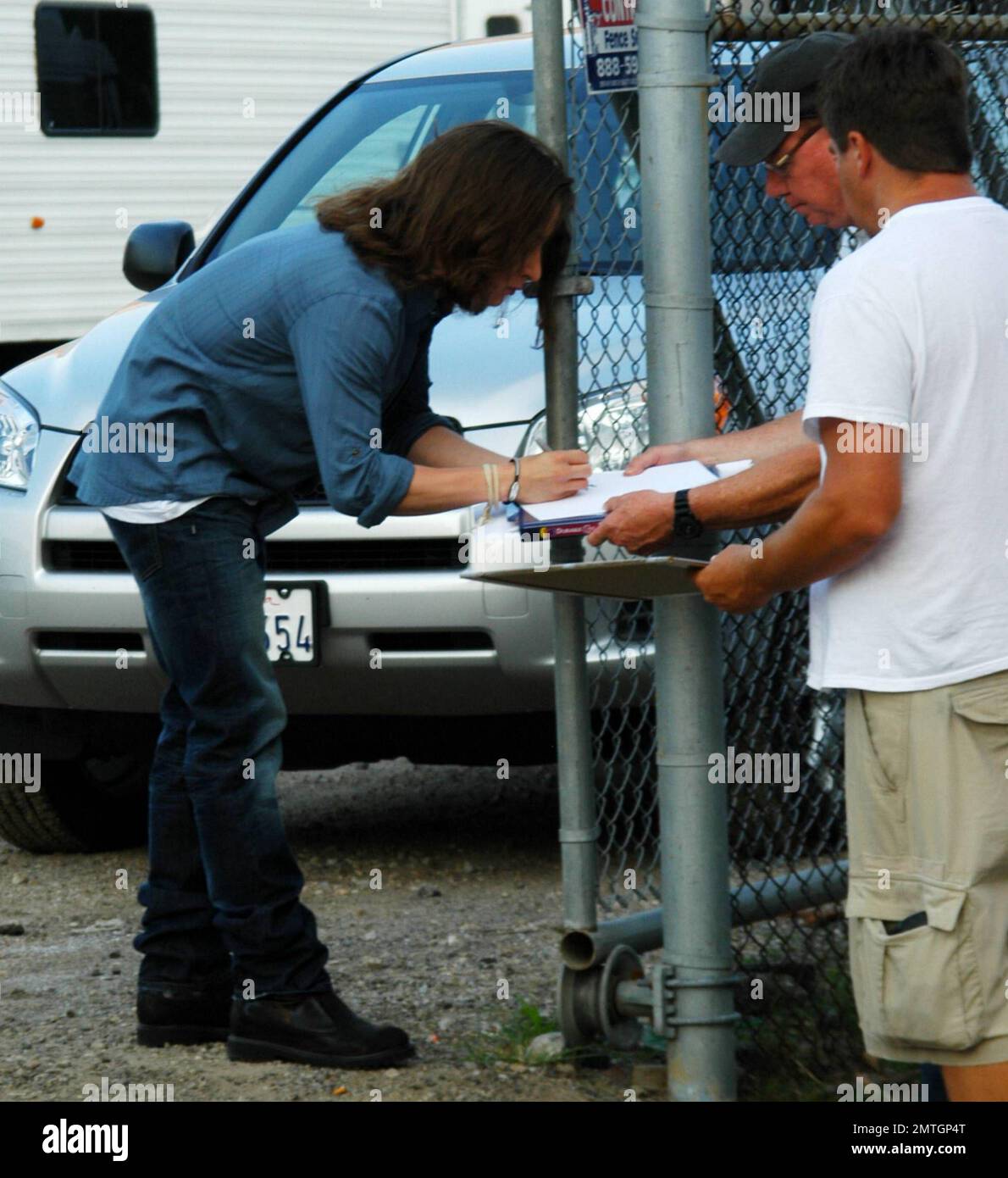 Rory Culkin shows off his long hair as he signs autographs for fans