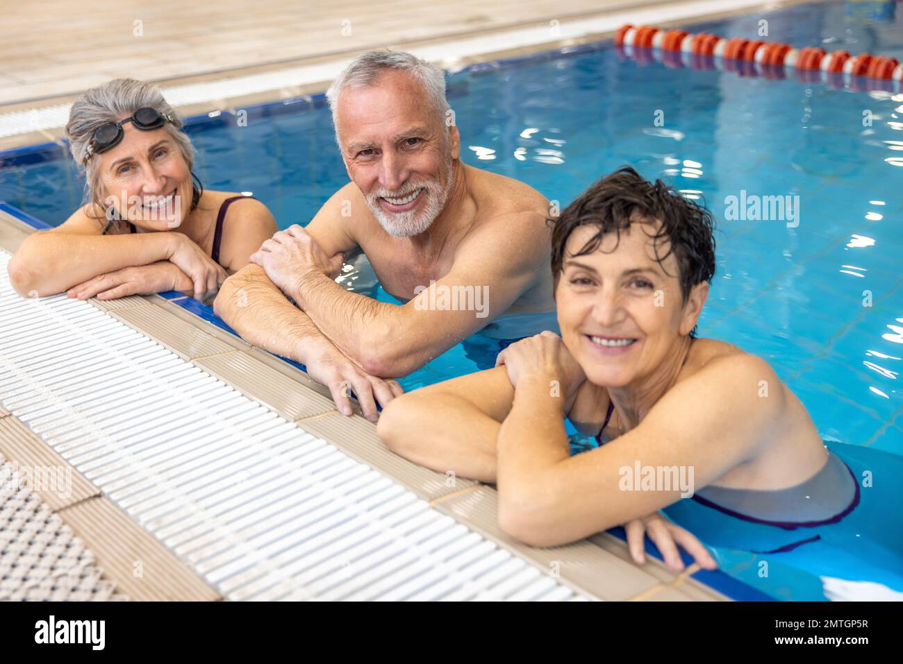 Group of seniors at the swimming pool looking happy and enjoyed Stock Photo