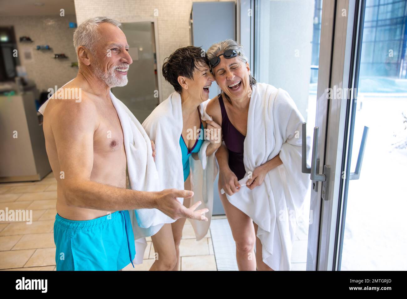 Senior in swimwear talking after swimming and looking enjoyed and energized Stock Photo