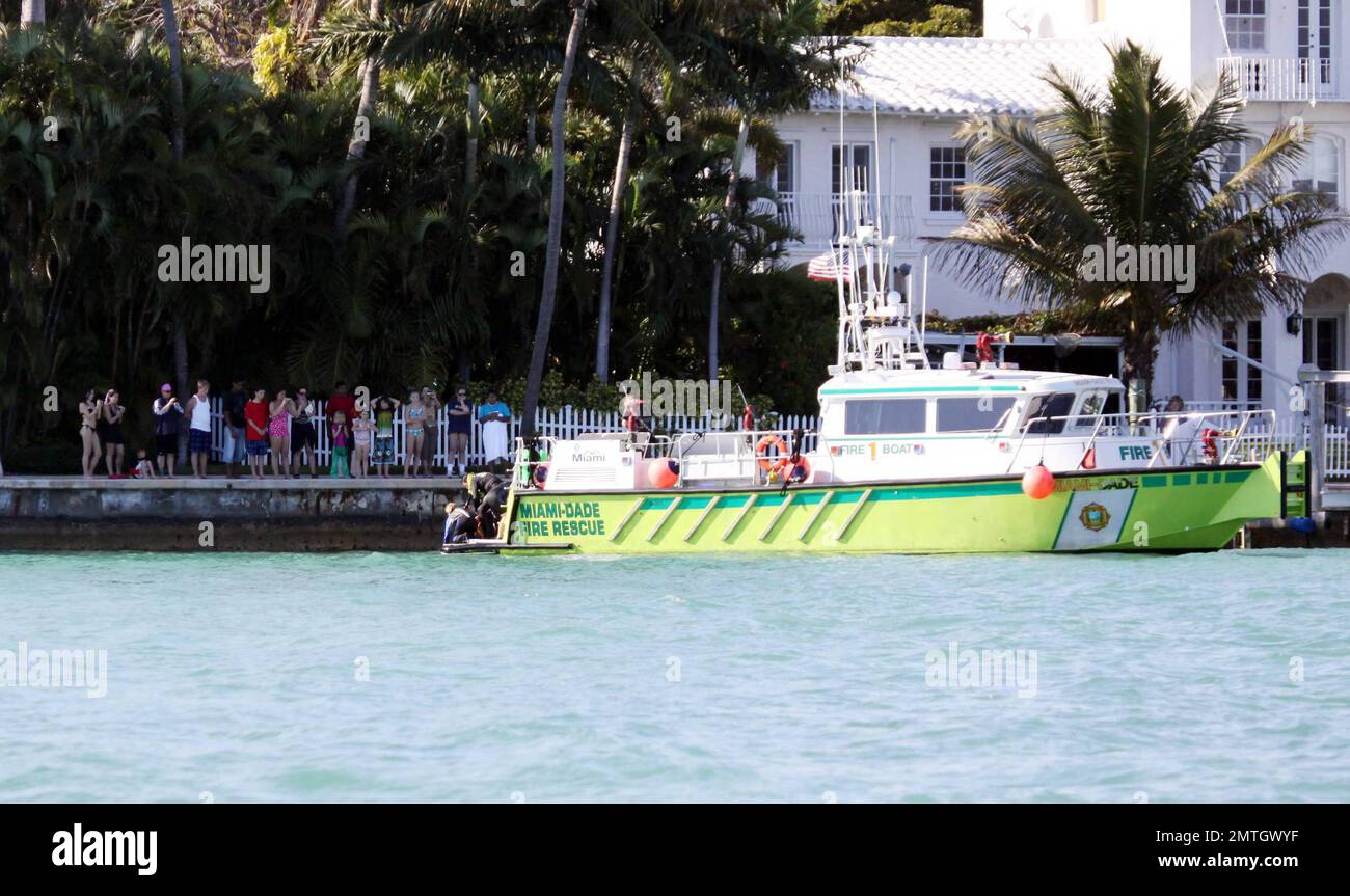 Rosie O'Donnell watches with a large crowd of people as Miami Dade Fire