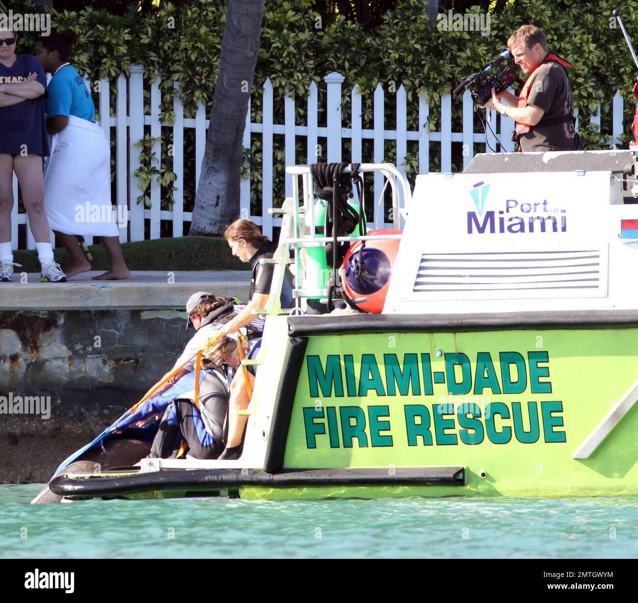 Rosie O'Donnell watches with a large crowd of people as Miami Dade Fire