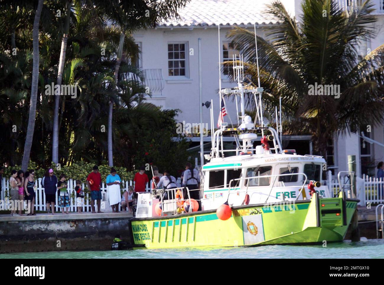 Rosie O'Donnell watches with a large crowd of people as Miami Dade Fire