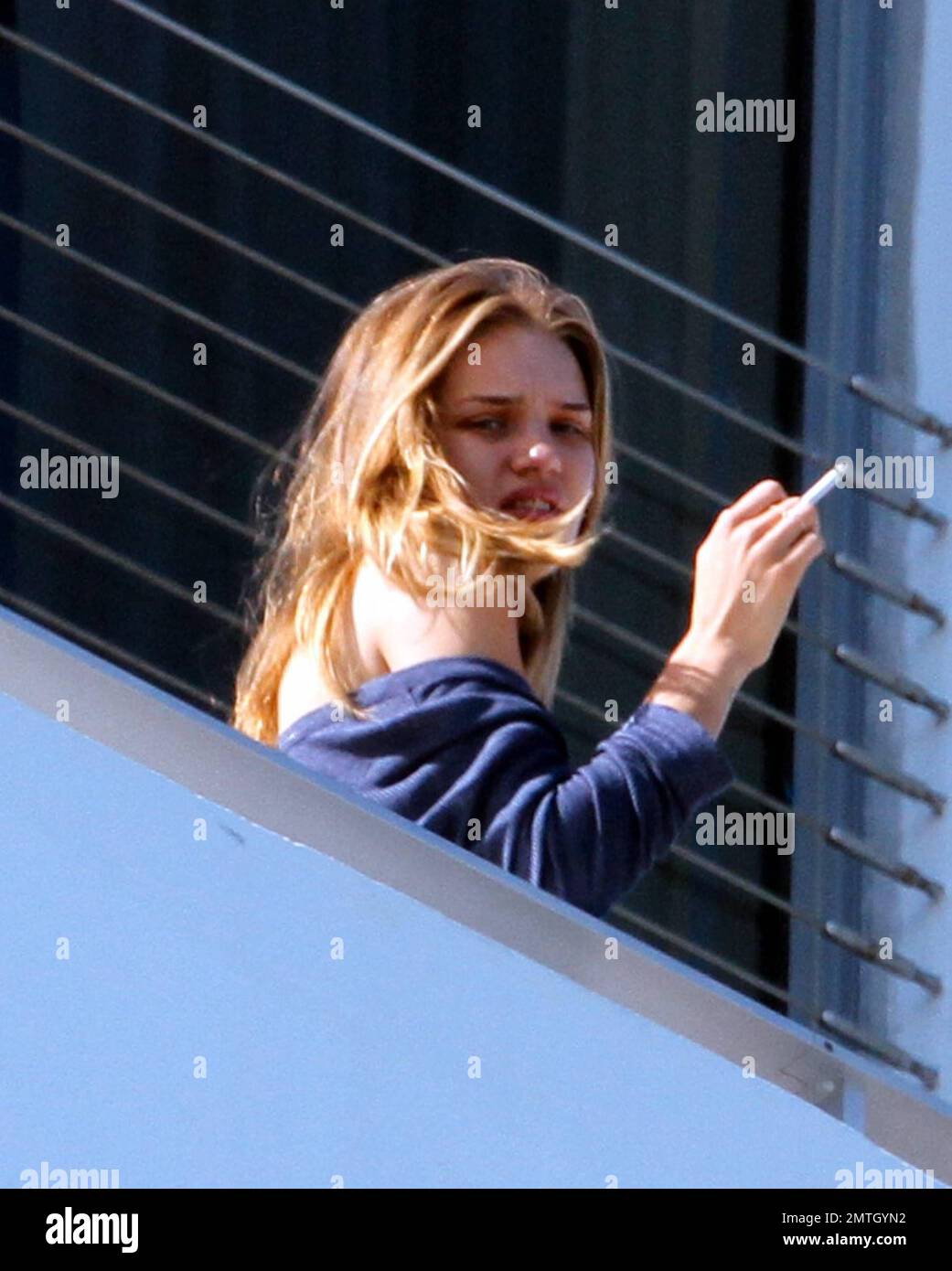 rosie huntington whiteley smoking cigarettes Rosie Huntington-Whiteley chats with pals and smokes a cigarette outside  her hotel in South Beach. The model is in town with her beau, Jason  Statham, to celebrate the new years at a