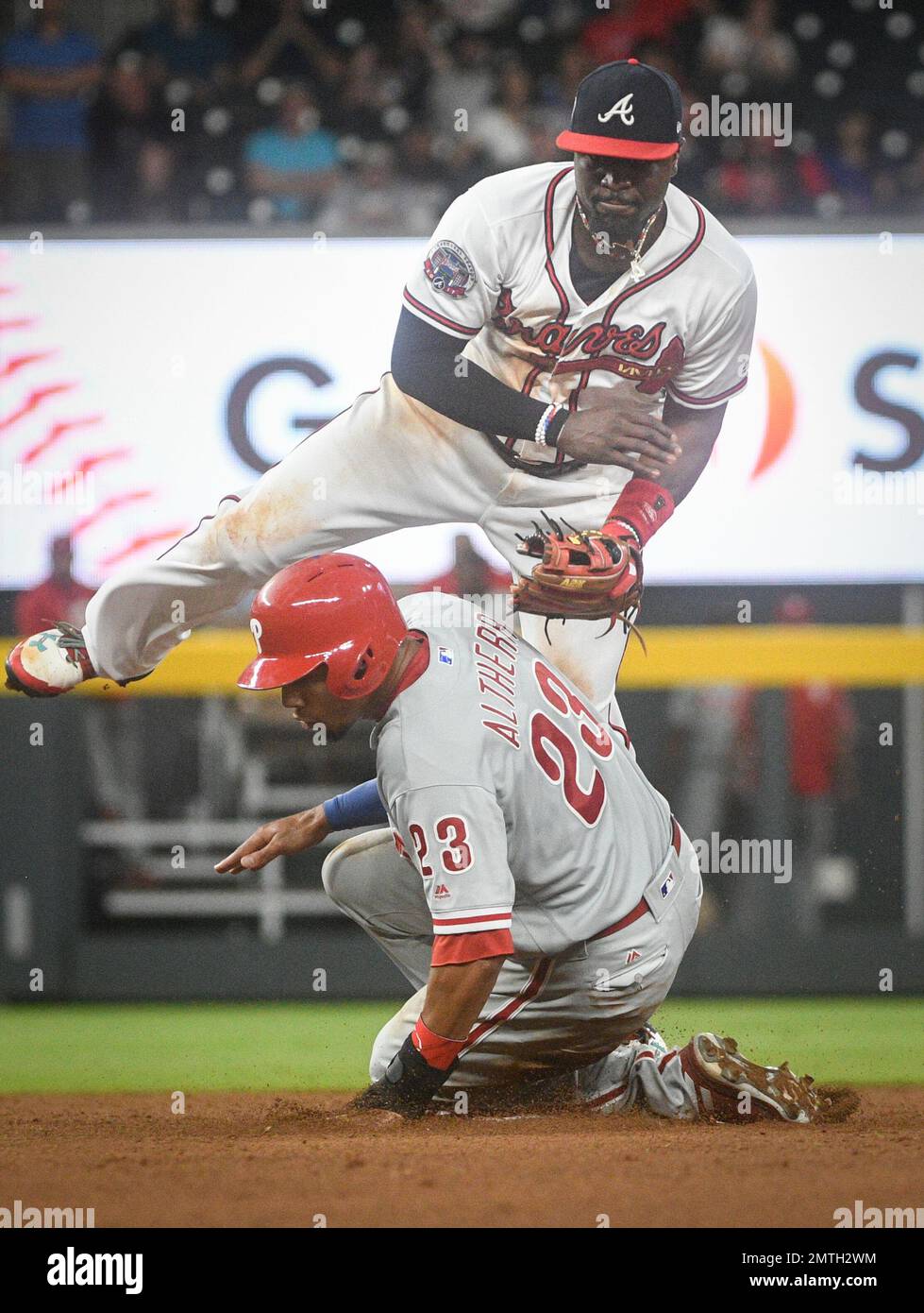 Atlanta Braves second baseman Brandon Phillips comes down on Philadelphia  Phillies' Aaron Altherr (23) as he turns a double play throwing out Maikel  Franco at first base during the ninth inning of