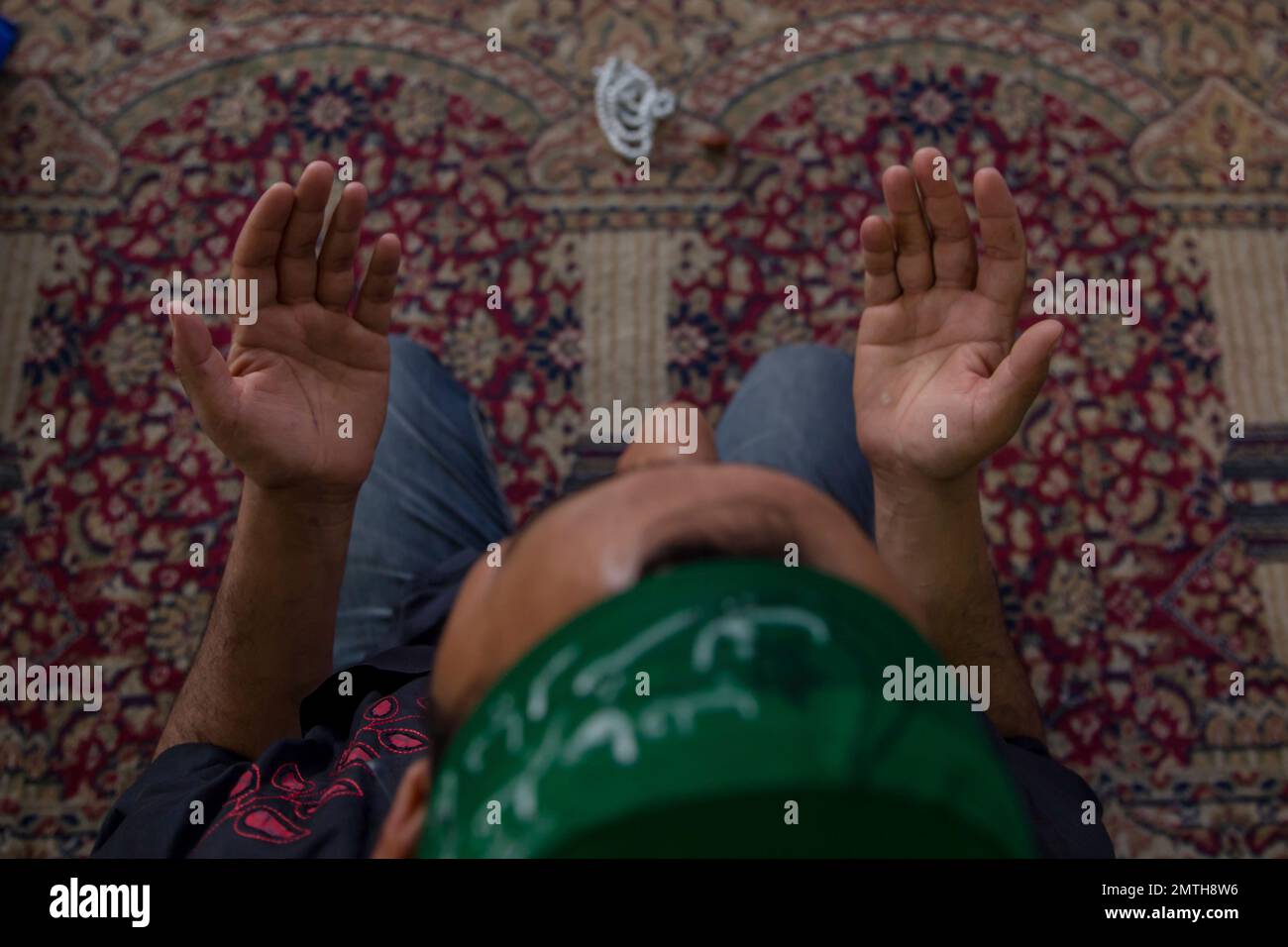A Kashmiri man prays inside the shrine of Sufi saint Shiekh Abdul Qadir ...