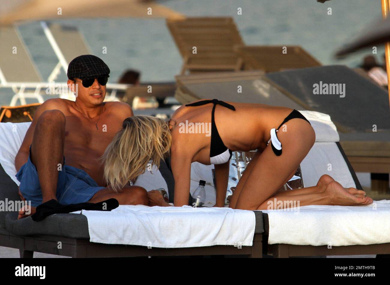 Rita Rusic and her handsome male companion spend an afternoon at the beach ahead of Christmas. Rita, an Italian-Croatian actress, displayed an amazing bikini figure despite being 51 years old. Rusic was also wearing a huge diamond ring on her left hand. Miami Beach, FL. 23rd December 2011. Stock Photo