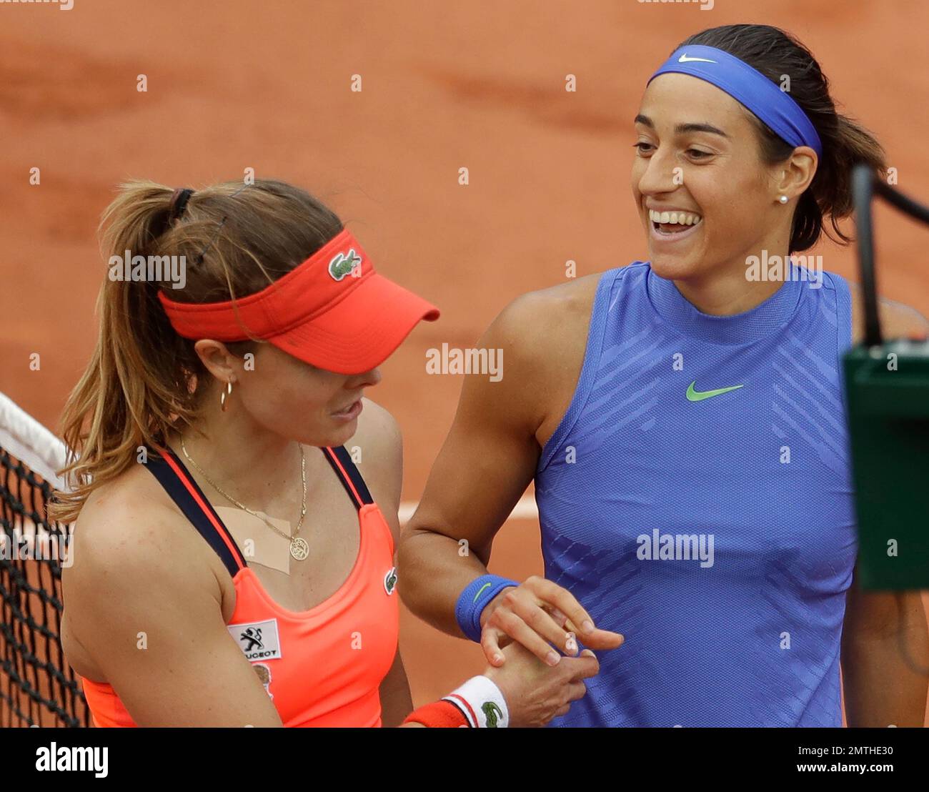 France's Caroline Garcia, right, smiles to compatriot Alize after she won their fourth
