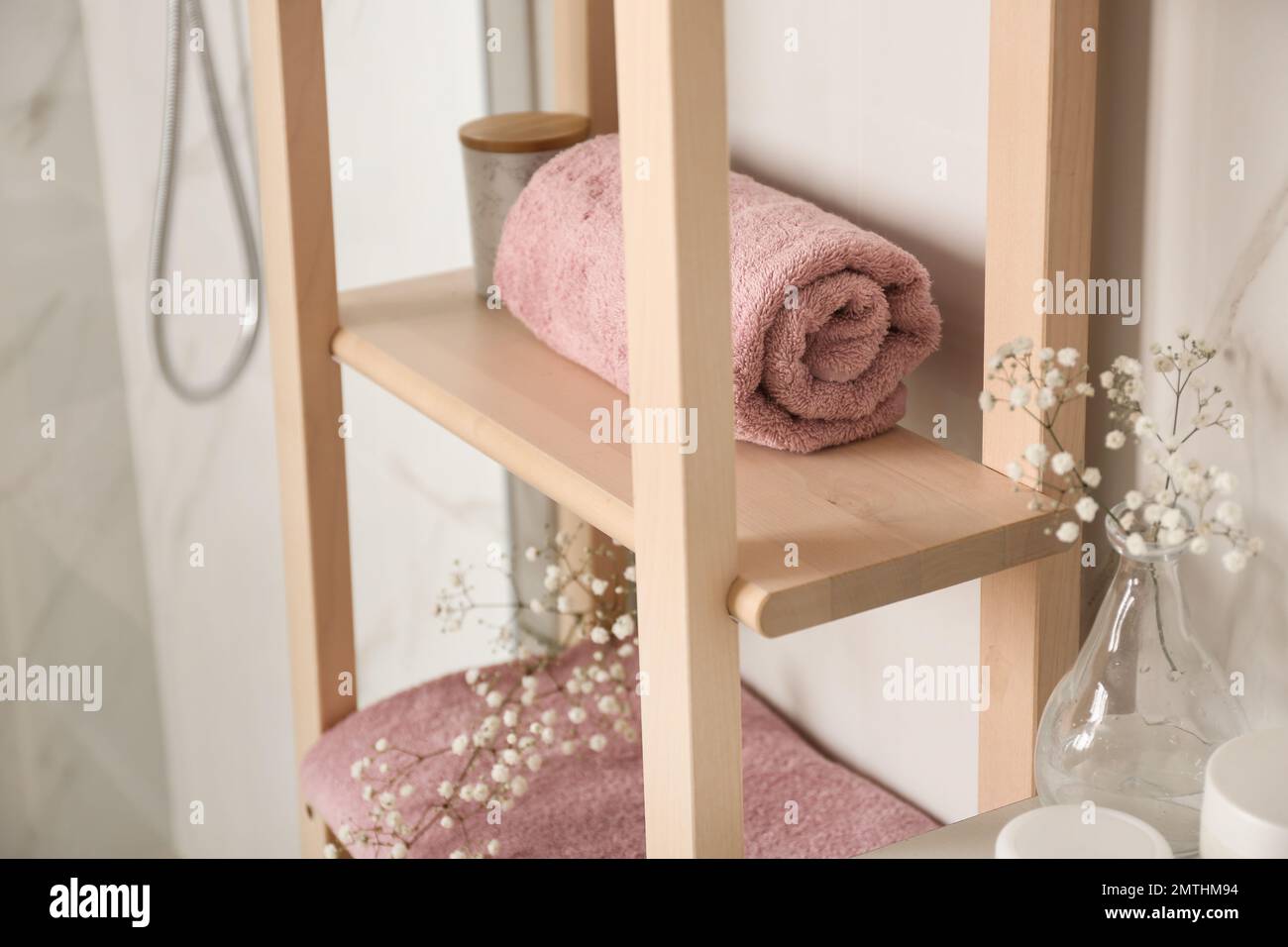 Shelving unit with clean towel in bathroom interior Stock Photo - Alamy