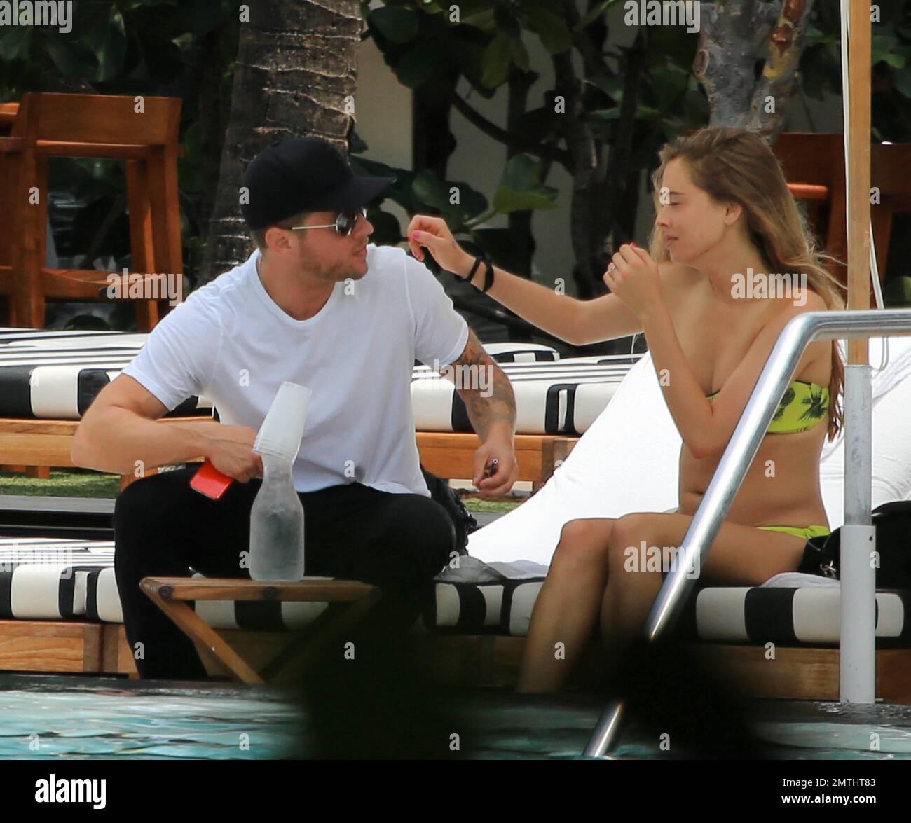 Ryan Phillippe and Paulina Slagter were spotted kissing while they hung out at their pool in South Beach. Ryan appeared to have a meeting booked as he had to leave his bikini beauty behind leaving the hotel with a back pack. Slender Paulina, who showed off a slightly rounded tummy, enjoyed a healthy lunch before cooling off in the pool in her yellow bikini. Miami Beach, FL. 11th June 2014. Stock Photo