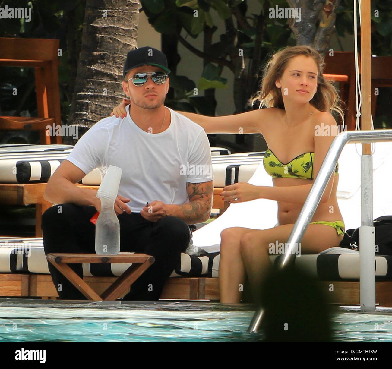 Ryan Phillippe and Paulina Slagter were spotted kissing while they hung out at their pool in South Beach. Ryan appeared to have a meeting booked as he had to leave his bikini beauty behind leaving the hotel with a back pack. Slender Paulina, who showed off a slightly rounded tummy, enjoyed a healthy lunch before cooling off in the pool in her yellow bikini. Miami Beach, FL. 11th June 2014. Stock Photo