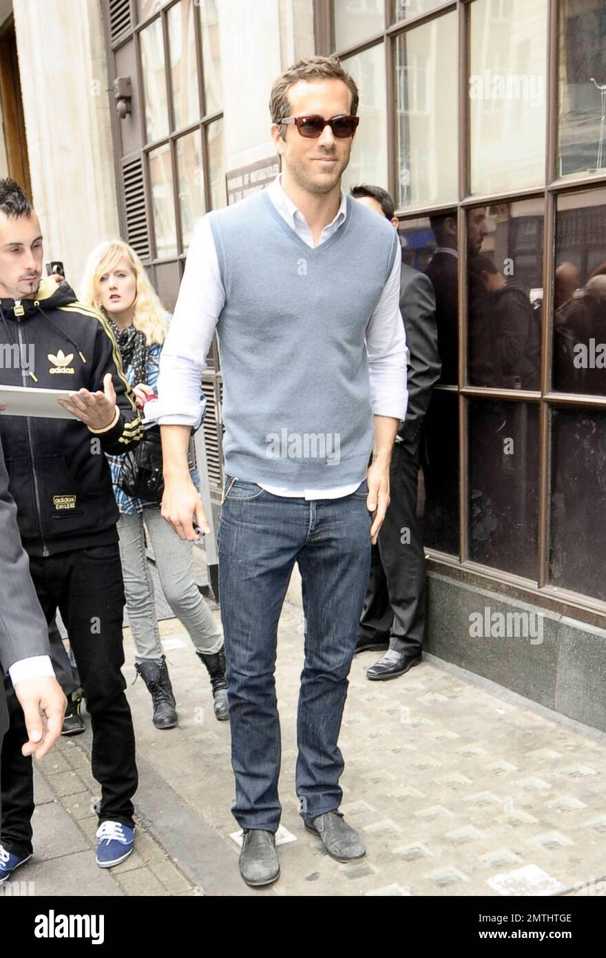 Green Lantern" star Ryan Reynolds wears a sweater vest and jeans as he  leaves BBC Radio 1 in London, UK. 6/10/11 Stock Photo - Alamy