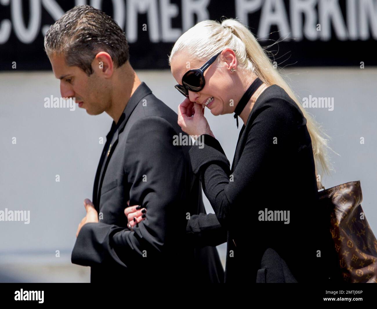 Delilah Island, right, gets emotional as she arrives for the funeral of