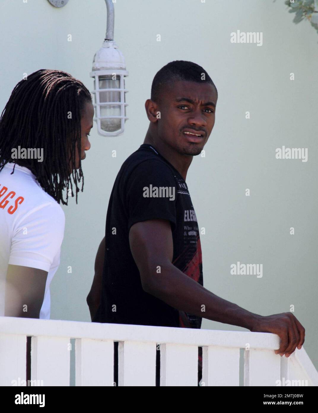 Chelsea forward Salomon Kalou shares a kiss with his girlfriend at his beachfront hotel and playfully pokes his tongue out as she walks off.  The couple later swam and frolicked in the warm Ocean.   Miami Beach, FL 6/30/2010 Stock Photo