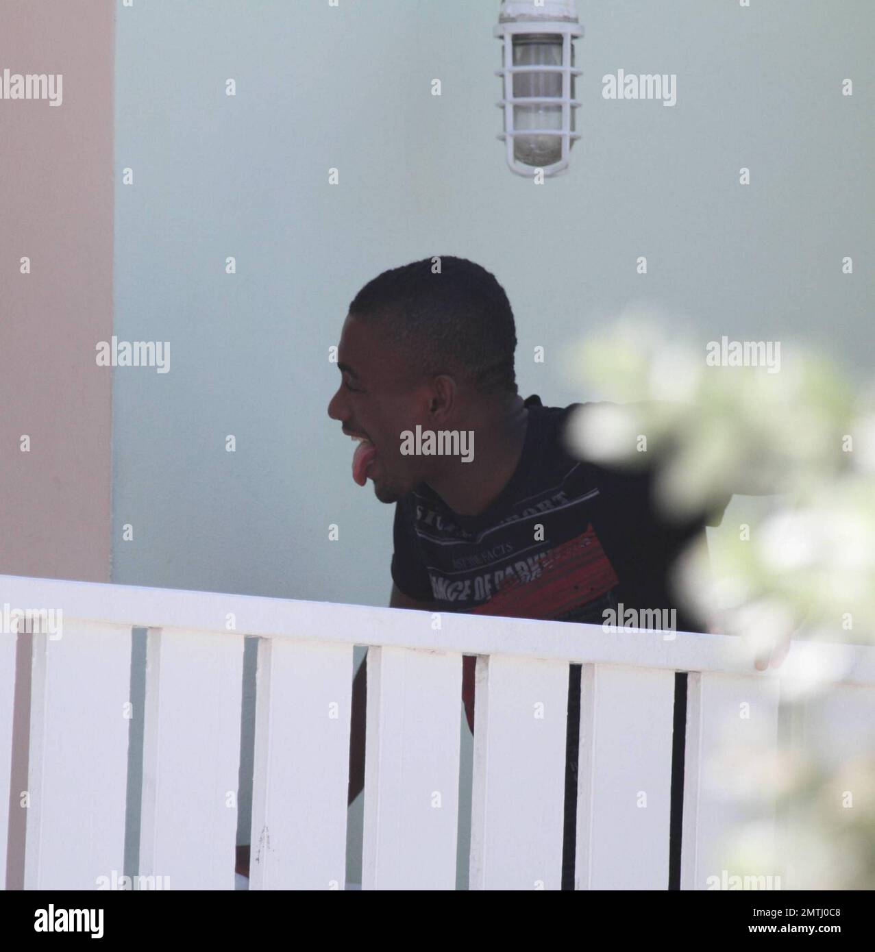 Chelsea forward Salomon Kalou shares a kiss with his girlfriend at his beachfront hotel and playfully pokes his tongue out as she walks off.  The couple later swam and frolicked in the warm Ocean.   Miami Beach, FL 6/30/2010 . Stock Photo