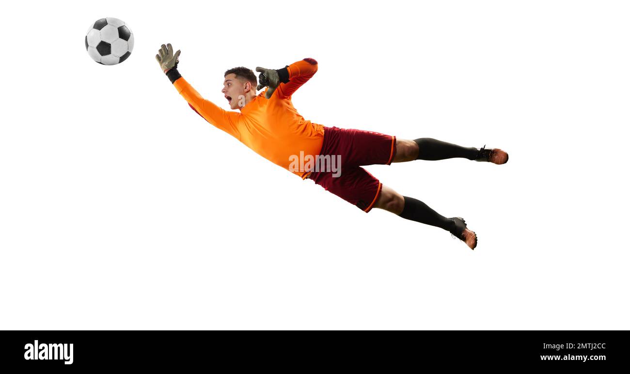 Young man, soccer football goalkeeper catches ball in jump isolated