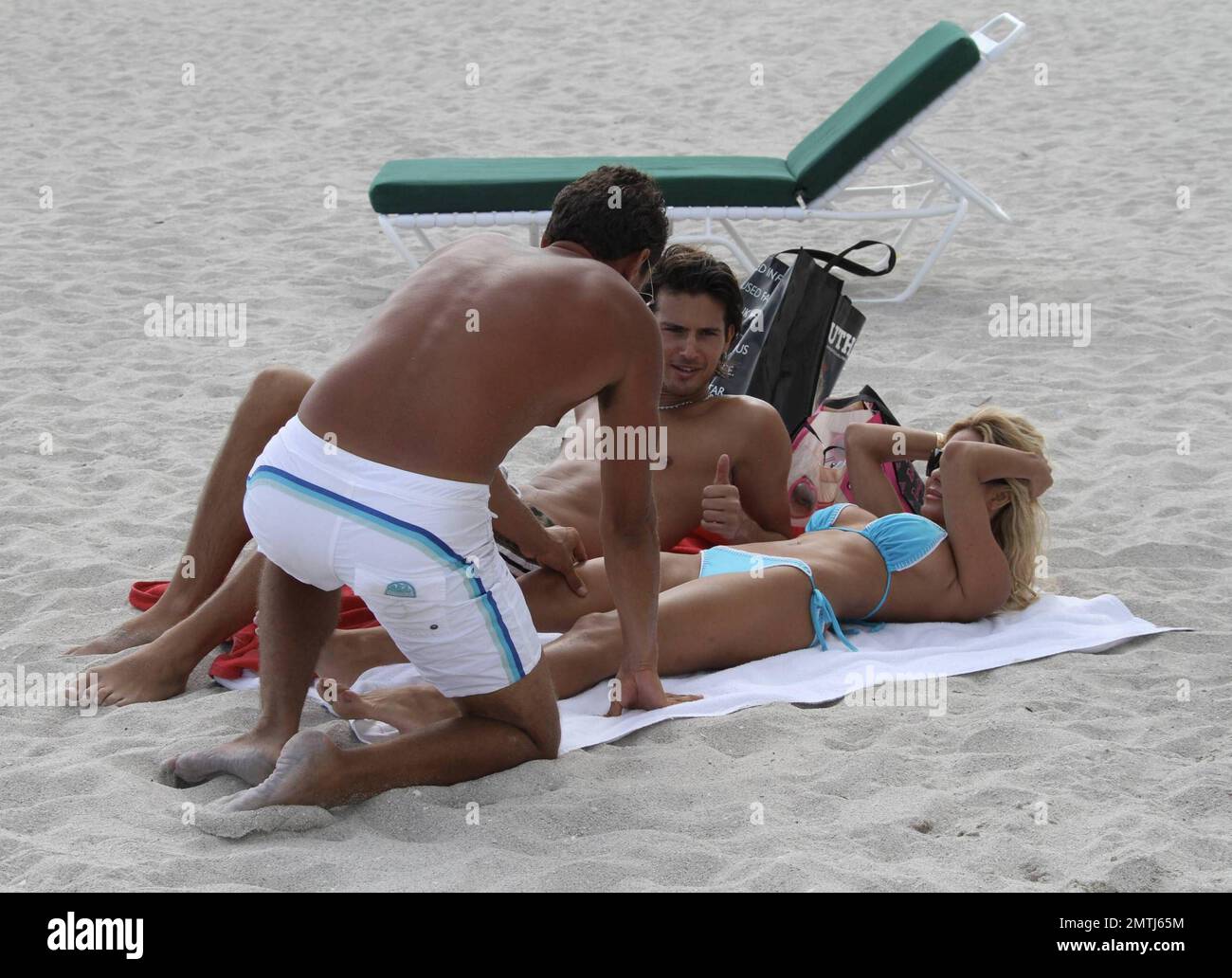 Shauna Sand gets a massage on the beach while her new husband Laurent  watches. Miami Beach, FL. 22411 Stock Photo - Alamy