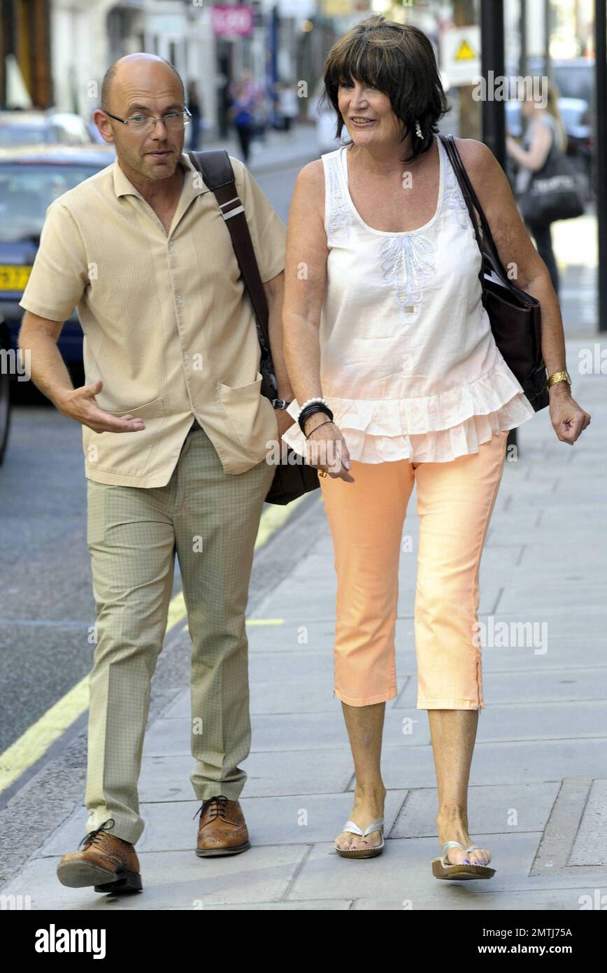 EXCLUSIVE!! '60s barefoot singer Sandie Shaw strolls with friends in the West End of London, UK. 6/30/10. Stock Photo
