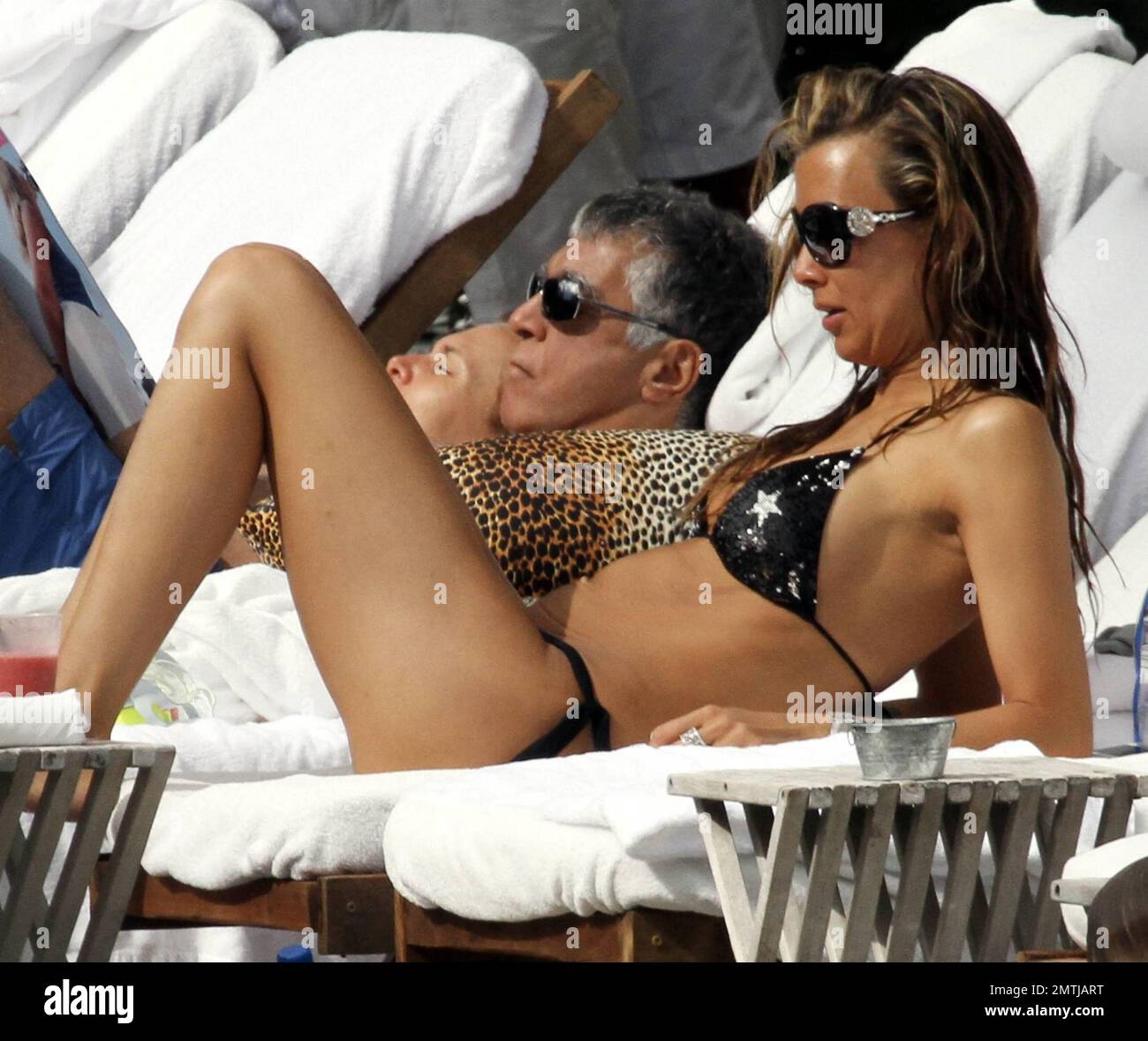 Tattooed Beauty Queen, Sarah Gerth, wife of German footballer Jermaine Jones, relaxes poolside at her luxury hotel in a star string bikini