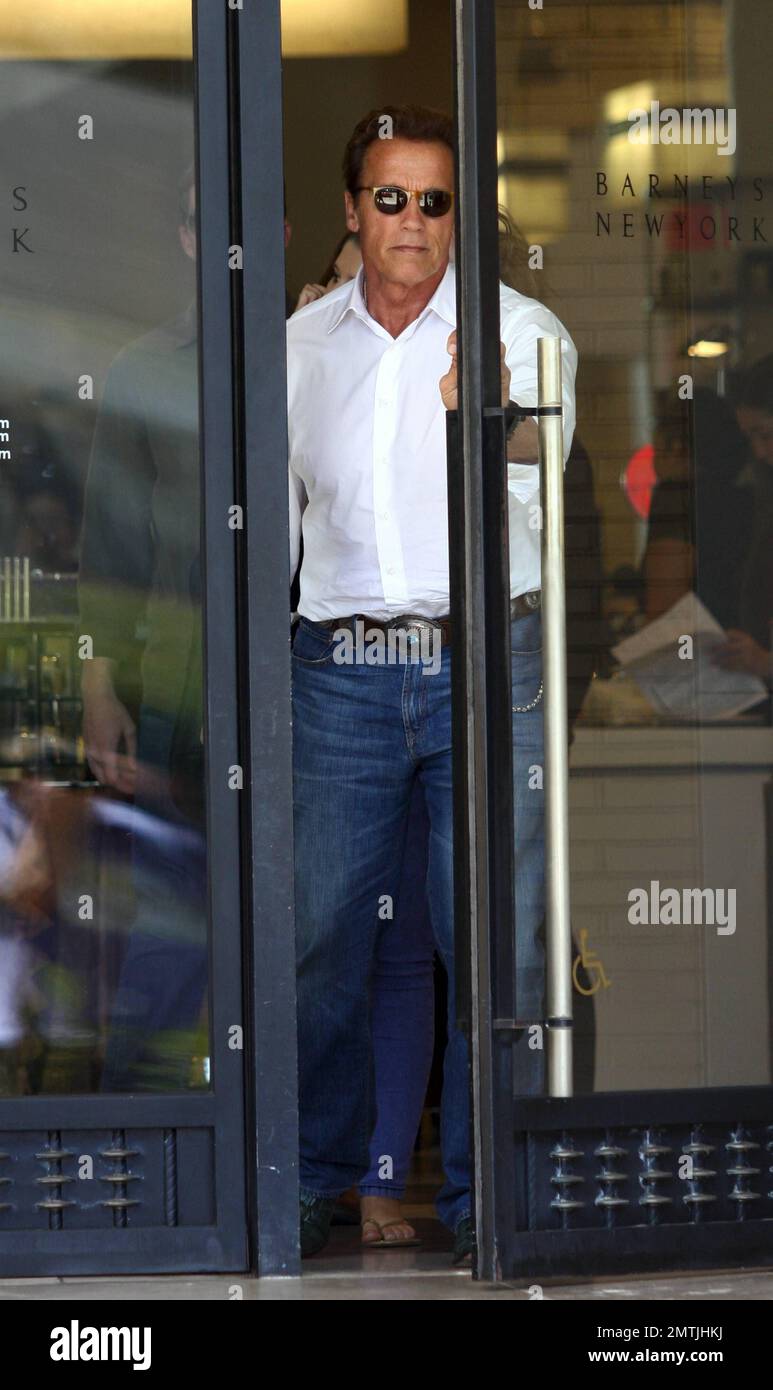 Wearing a western-styled outfit complete with green crocodile cowboy boots, Arnold Schwarzenegger joins daughter Christina for some shopping at Barney's New York in Los Angeles, CA. 8/8/11. Stock Photo