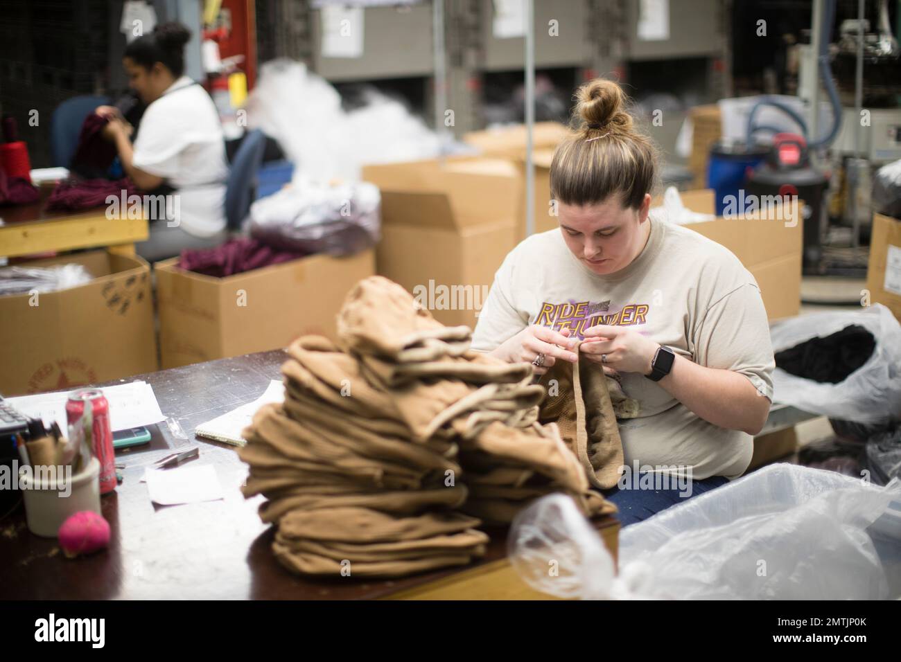 A worker takes part in the manufacturing of hats the Bollman Hat