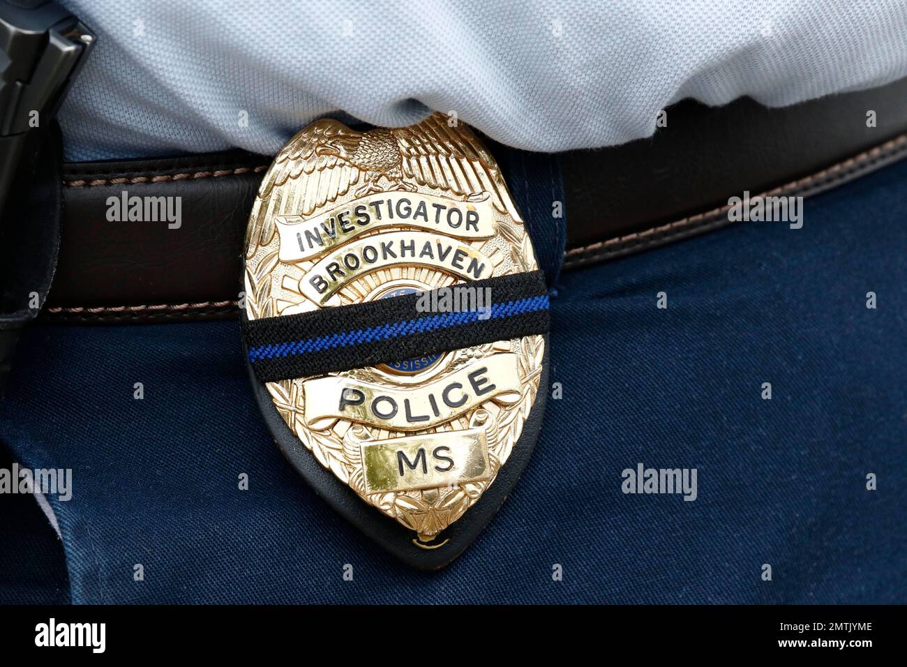 A Brookhaven police investigator has a black and blue stripe across her ...