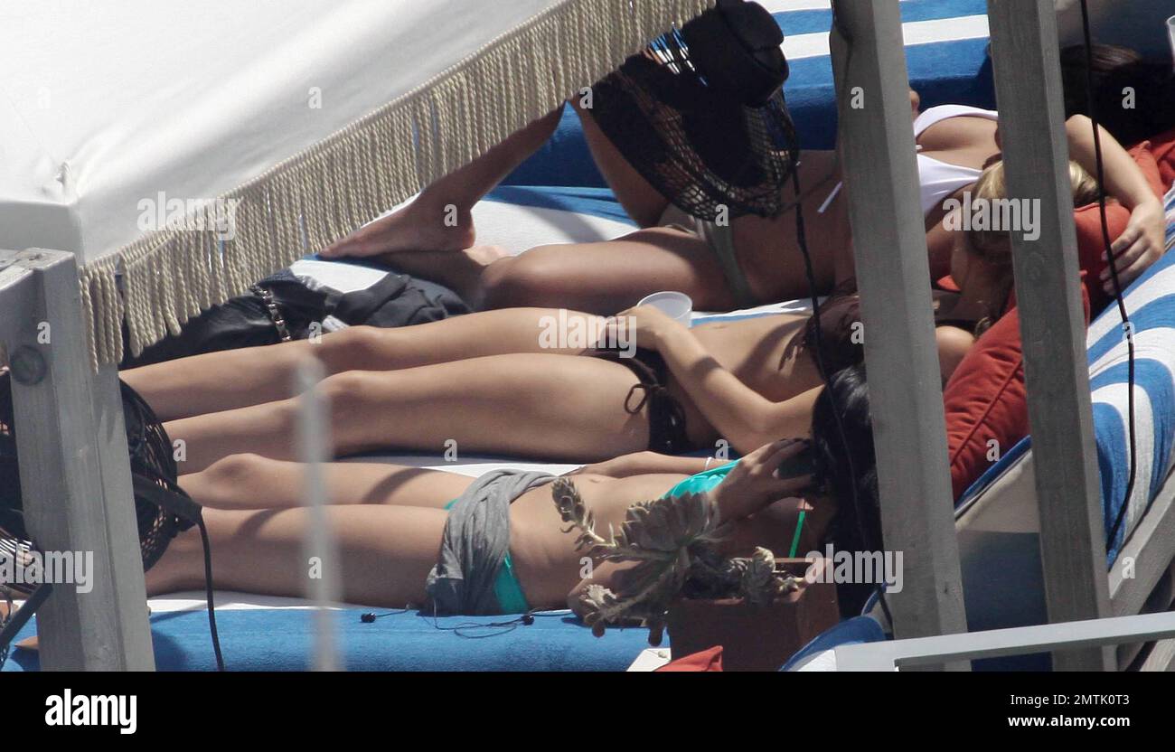 Selena Gomez shows off her fit figure in a blue bikini as she lounges  poolside with some female friends. While there, Gomez chatted on the phone  and sipped on a cold Starbucks