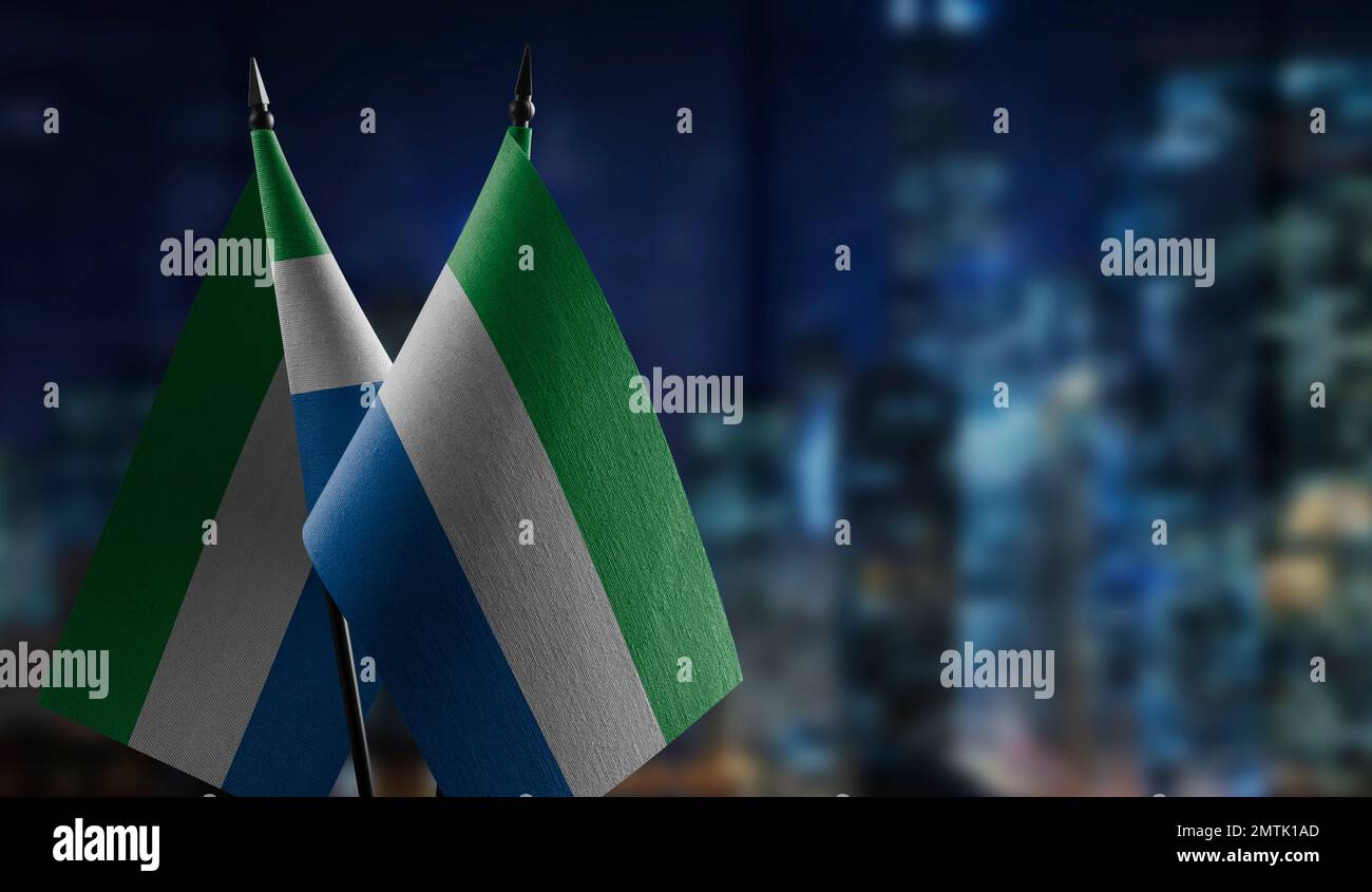 Small flags of the Sierra Leone on an abstract blurry background Stock ...