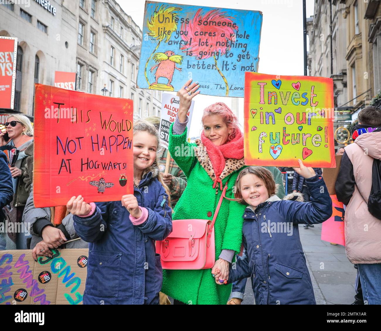 London, UK. 01st Feb, 2023. A mum and children participate with placards. Thousands participate in the march. The TUC (trades union congress) and many of the unions, including the PCS (Public and CommercialServices Union), Teacher's Unions and others march through London to demand better conditions and pay today, starting in Portland Square ending in Parliament Square and ending outside Downing Street on Whitehall, where a a stage sees speakers and a petition is then handed in to Downing Street. Credit: Imageplotter/Alamy Live News Stock Photo