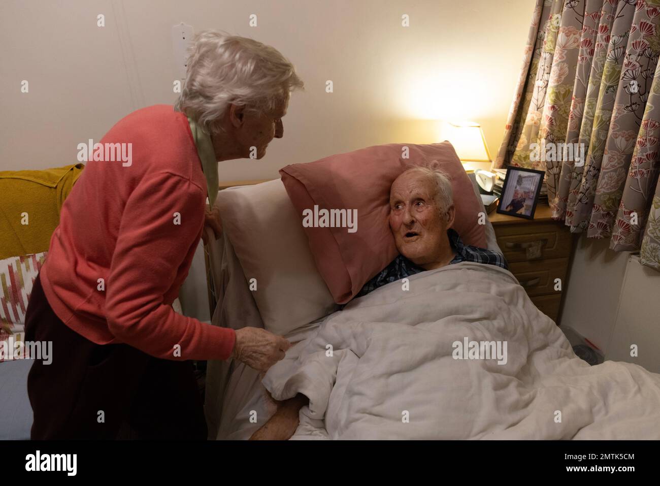 Elderly couple in the eighties together in a residents nursing home bedroom, England, UK Stock Photo