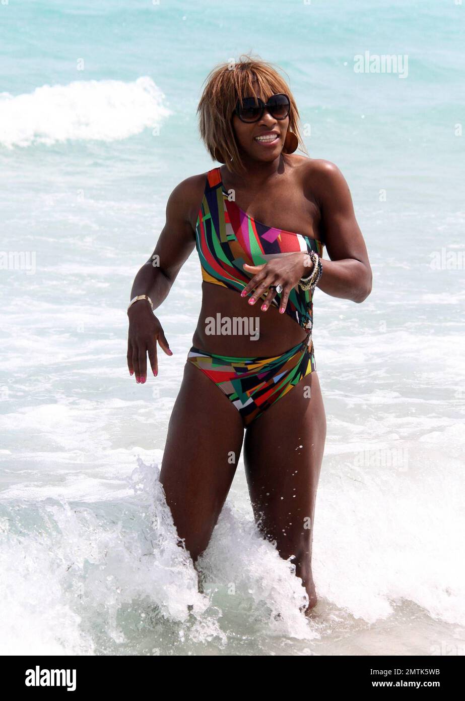 Serena Williams shows off her form in a cutaway bathing suit on the beach. Miami, FL. 3/25/10.   . Stock Photo