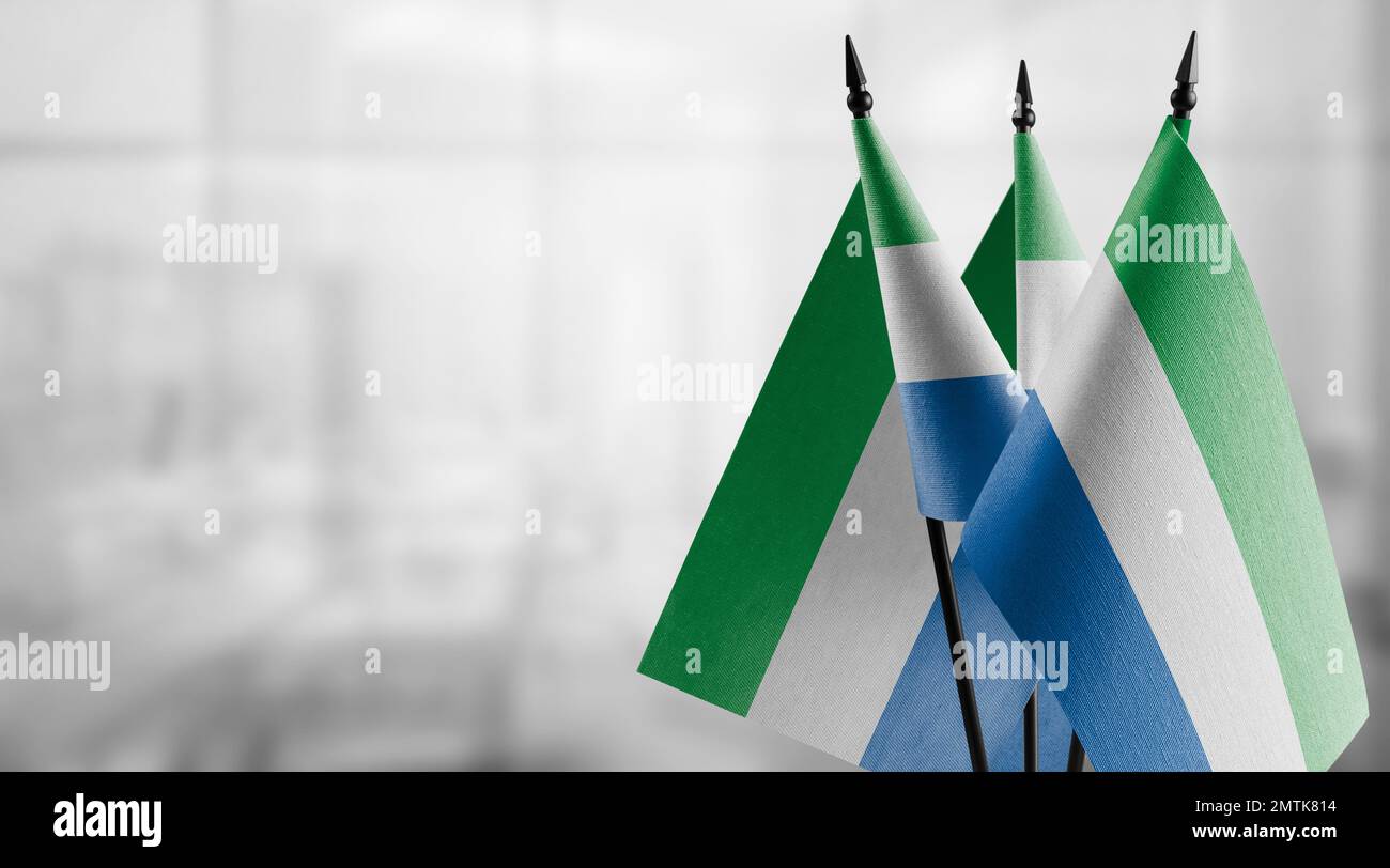 Small flags of the Sierra Leone on an abstract blurry background Stock ...